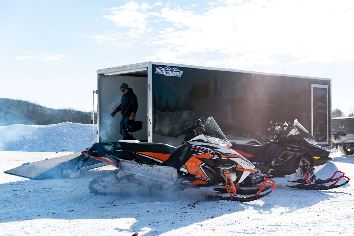 Man with Trailer and Snowmobiles